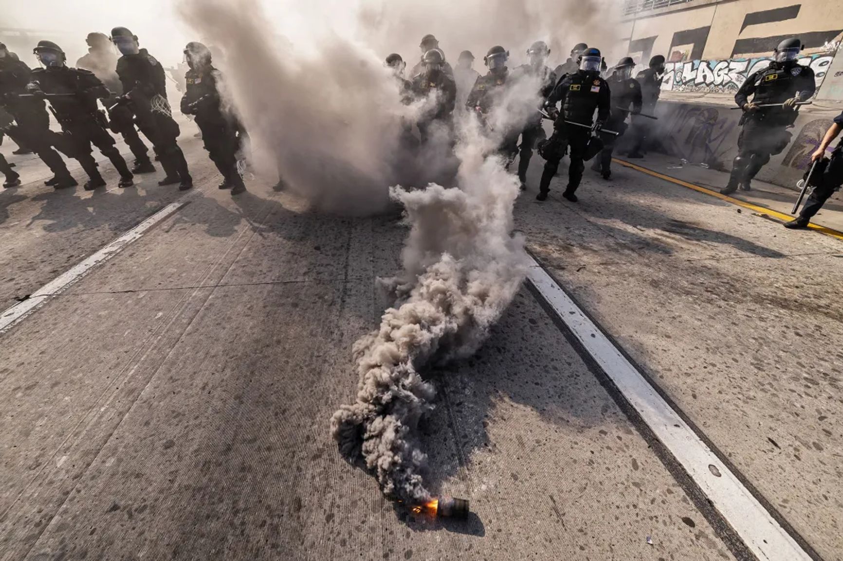 California Highway Patrol officers move to clear protesters from the 101 Freeway in downtown Los Angeles on June 8, 2025.
