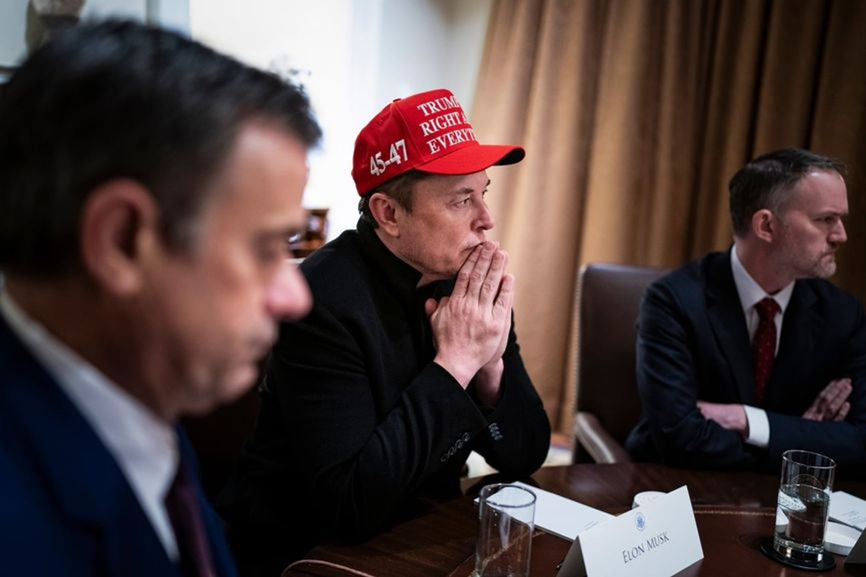 Elon Musk listens to President Donald Trump during a cabinet meeting on March 24.