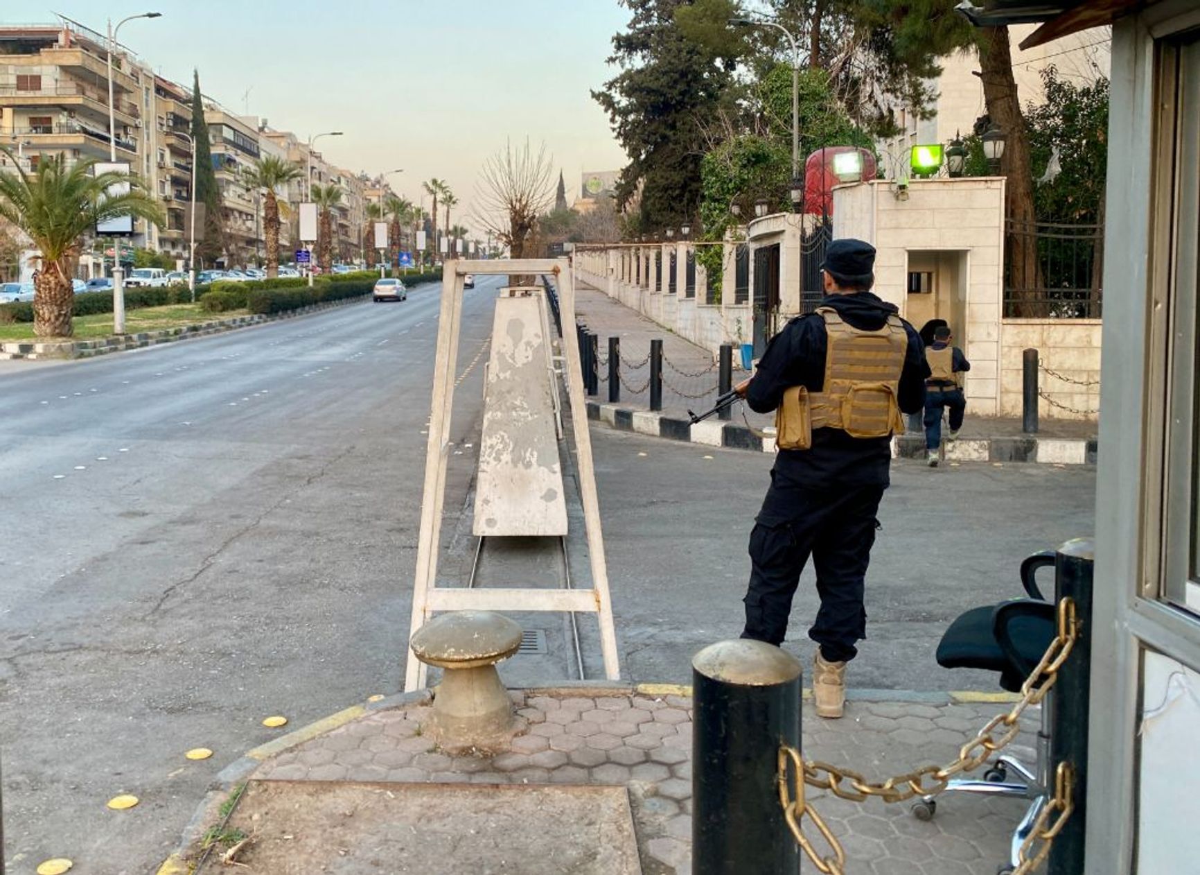 A Syrian security officer guards a checkpoint in Damascus.